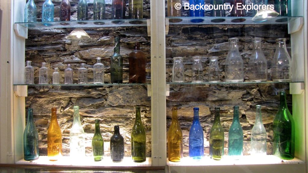 Colored bottles in museum selves