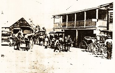Historical picture of mountain house with wagons in the front.