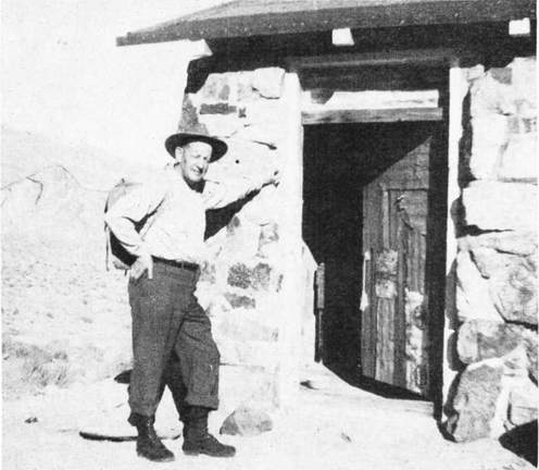 Photo of Asaa Russell in front of the Geologist cabin