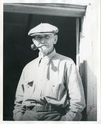 Photo of Carl Mengel with pipe and hat